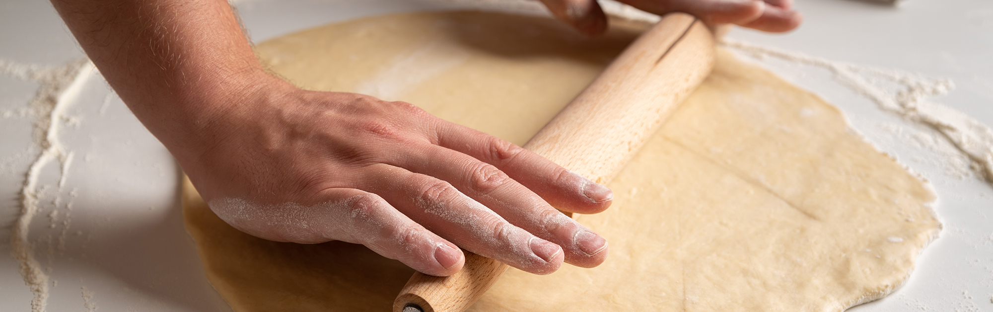 close-up-person-spreading-dough