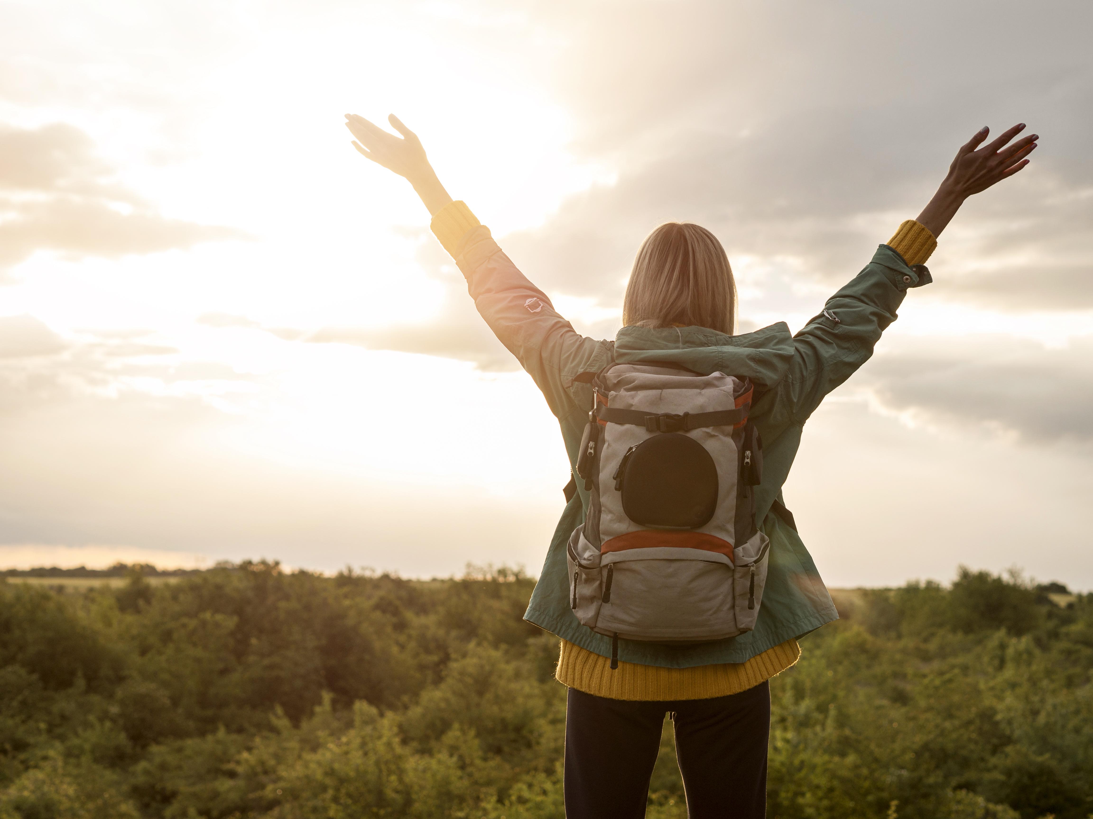 woman-with-backpack-sunset-nature